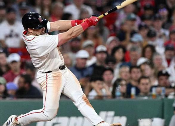 Boston Red Sox batter swinging at Fenway Park