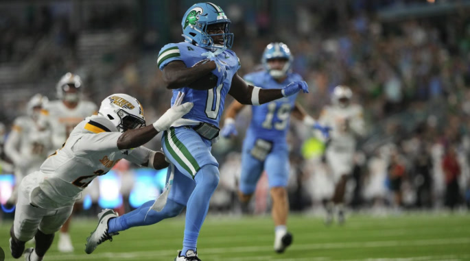 Tulane running back Maurice Turner breaks away from a Southern Miss defender