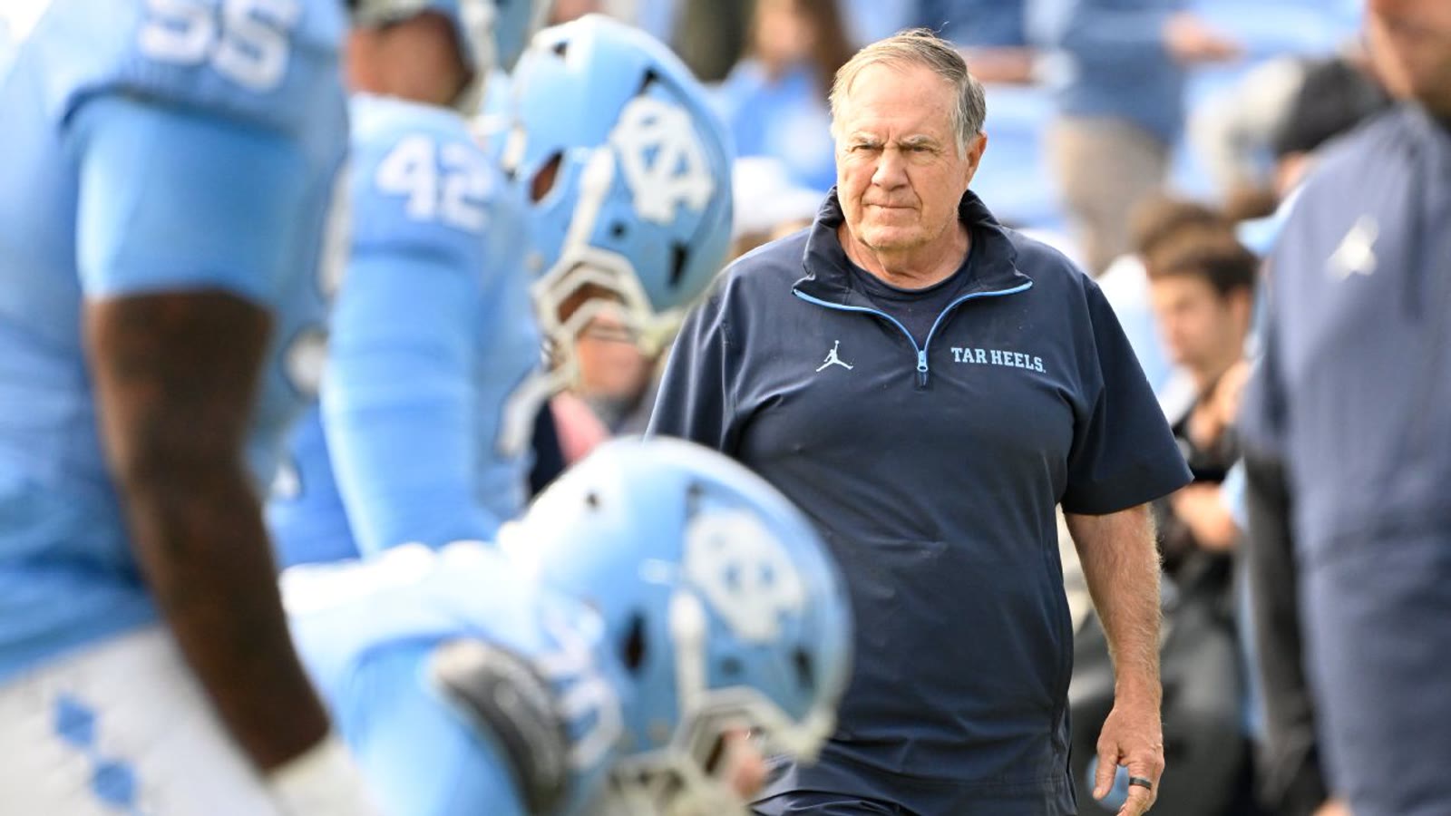 Bill Belichick walking through North Carolina players during warmups